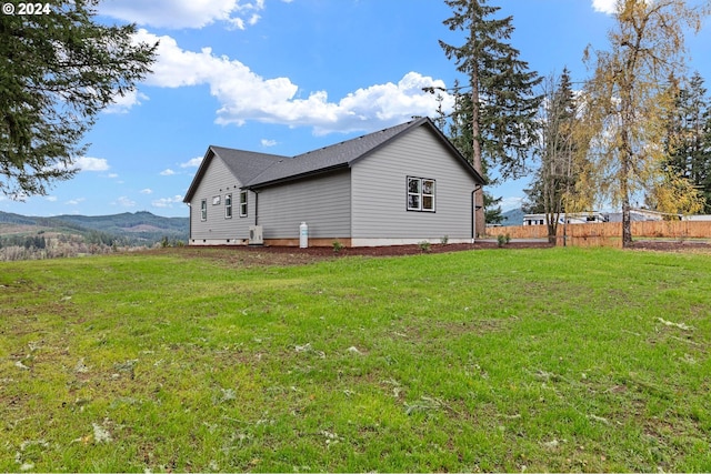 view of home's exterior featuring a mountain view and a yard