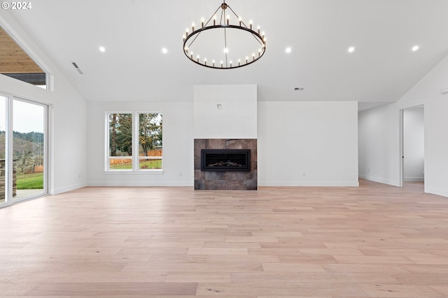 31248 Valley View Ln, Cottage Grove, OR 97424 - unfurnished living room featuring light wood-type flooring, a tile fireplace, a chandelier, baseboards, and high vaulted ceiling