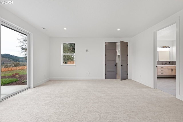 31248 Valley View Ln, Cottage Grove, OR 97424 - unfurnished bedroom with access to outside, light colored carpet, recessed lighting, baseboards, and ensuite bathroom