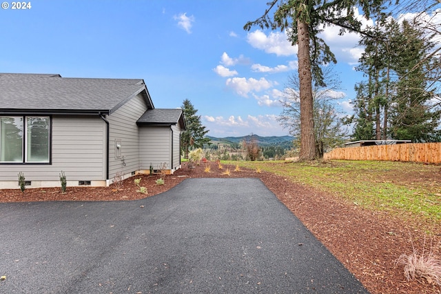 31248 Valley View Ln, Cottage Grove, OR 97424 - view of home's exterior featuring a shingled roof, asphalt driveway, a mountain view, and a patio area