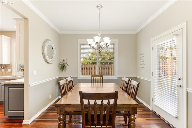 dining room with ornamental molding, a chandelier, and dark hardwood / wood-style floors