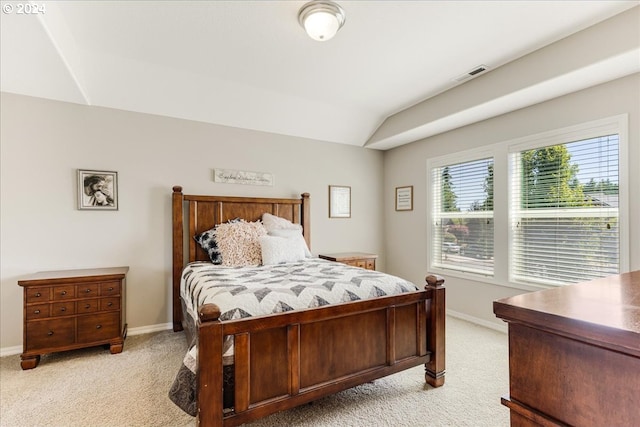 carpeted bedroom with lofted ceiling