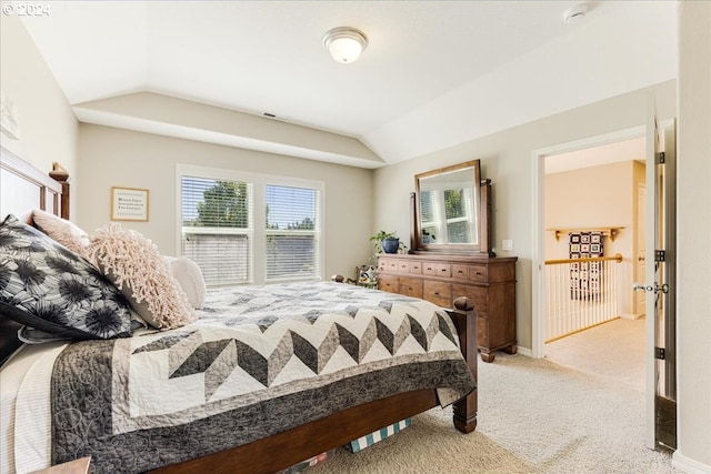 carpeted bedroom featuring vaulted ceiling