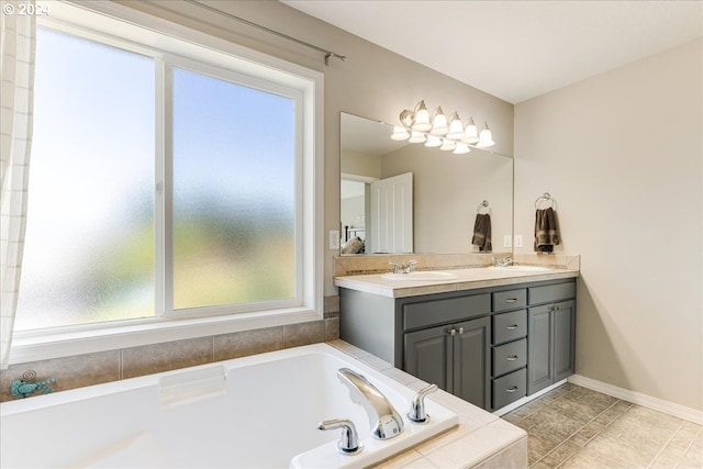 bathroom featuring vanity and tiled bath