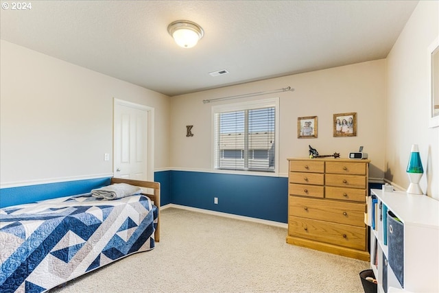 carpeted bedroom with a closet