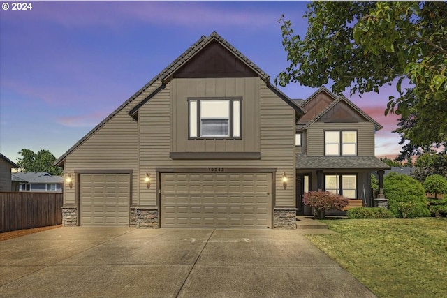 view of front of house featuring a garage and a yard