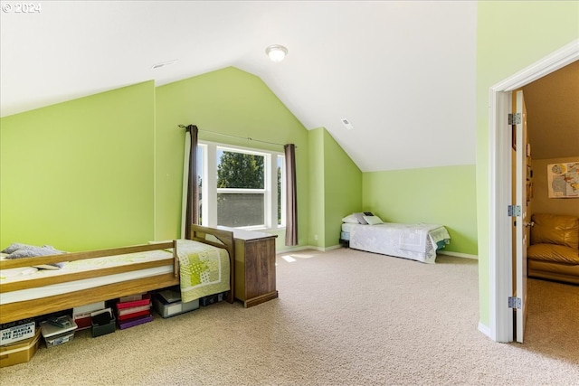 carpeted bedroom with vaulted ceiling