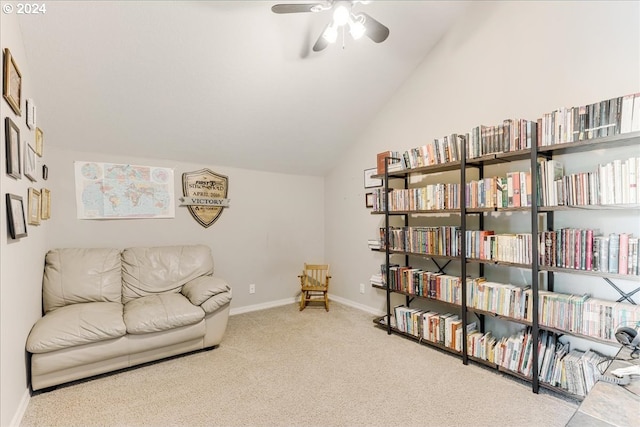 living area with carpet floors, ceiling fan, and lofted ceiling