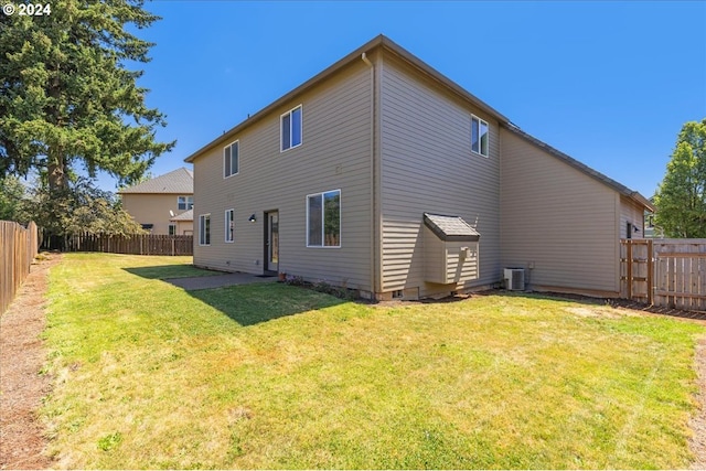 back of house featuring a patio area, central AC, and a yard