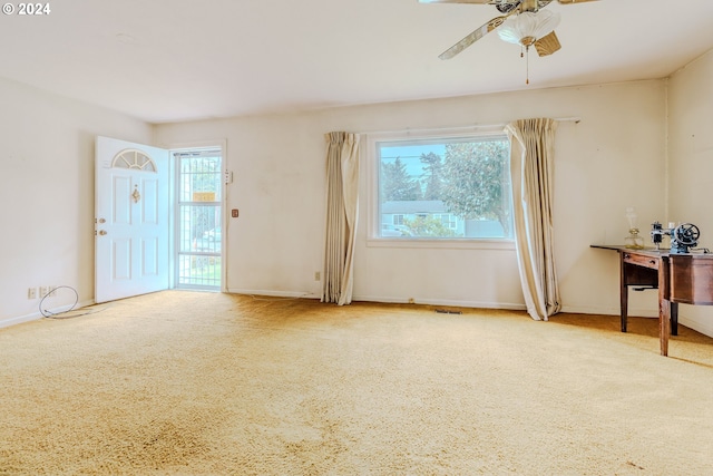 interior space featuring carpet floors, a wealth of natural light, and ceiling fan