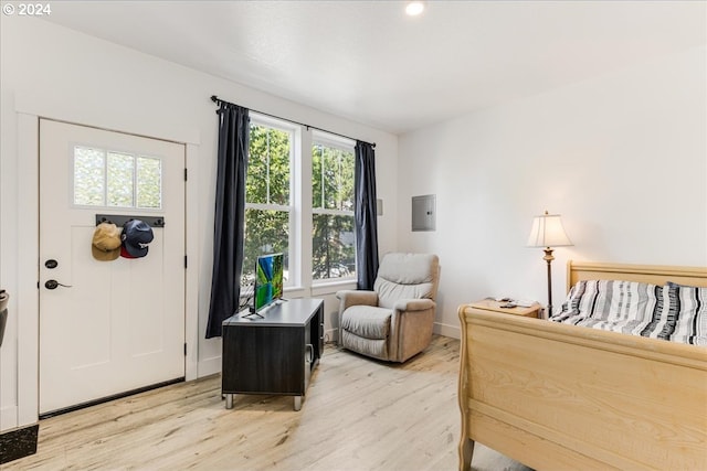 interior space with electric panel and light hardwood / wood-style flooring