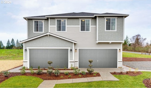 view of front of property featuring a garage and a front lawn