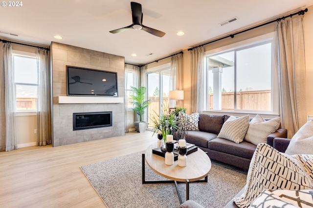 living room featuring visible vents, ceiling fan, recessed lighting, a fireplace, and wood finished floors