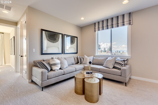 carpeted living area with recessed lighting, visible vents, and baseboards