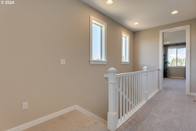 hall featuring recessed lighting, baseboards, an upstairs landing, and carpet