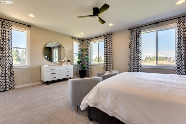 bedroom with multiple windows, light colored carpet, and recessed lighting