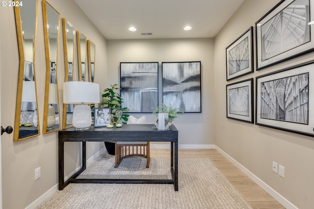 office space with recessed lighting, visible vents, baseboards, and wood finished floors