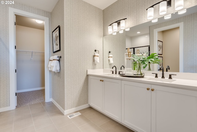 full bathroom featuring a sink, baseboards, a stall shower, and wallpapered walls