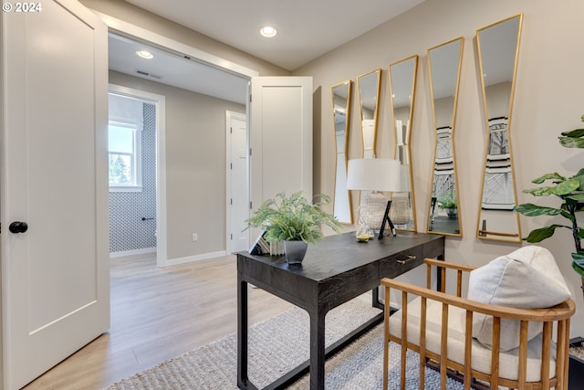 office featuring light wood-type flooring, visible vents, baseboards, and recessed lighting