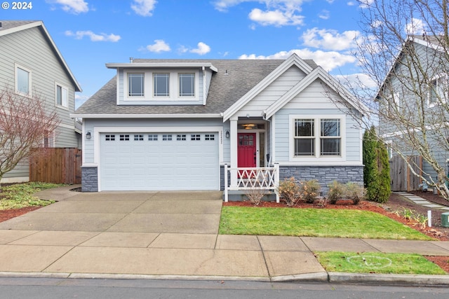 craftsman-style house featuring a garage and a front lawn