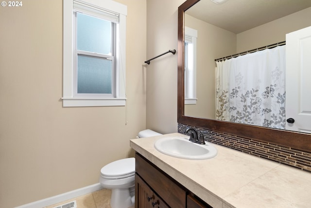 bathroom with tile patterned floors, vanity, tasteful backsplash, and toilet