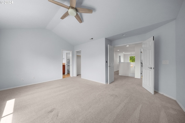 unfurnished bedroom with ceiling fan, lofted ceiling, and light colored carpet