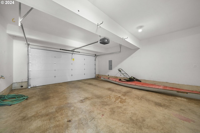 garage featuring electric panel and a garage door opener