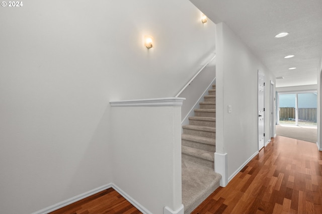 staircase featuring hardwood / wood-style floors