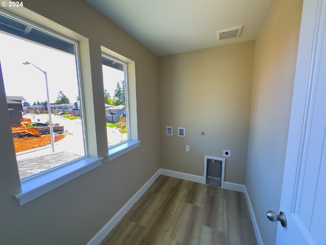 laundry area with electric dryer hookup, washer hookup, dark hardwood / wood-style floors, and a textured ceiling