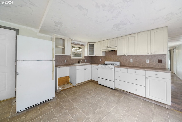 kitchen featuring white cabinetry, white appliances, and sink