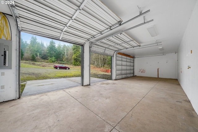 garage with electric panel and a carport