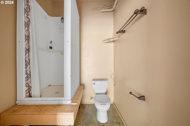 bathroom featuring toilet and a shower