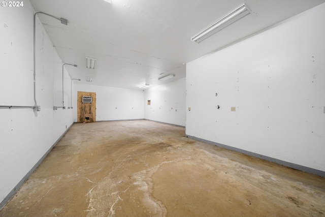 unfurnished room featuring concrete floors