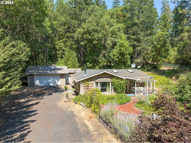 view of front of property featuring a garage and an outbuilding