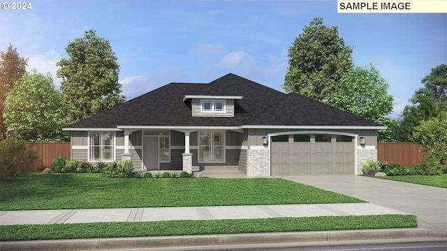 view of front of property featuring a front yard, covered porch, and a garage