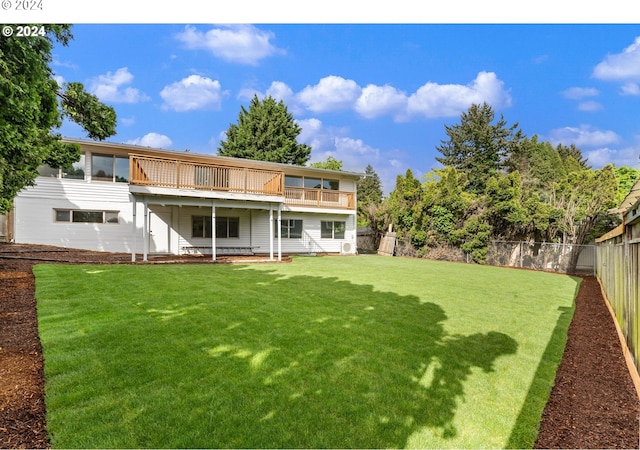 rear view of property featuring a yard