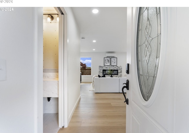 hall featuring light hardwood / wood-style flooring and a wall mounted AC