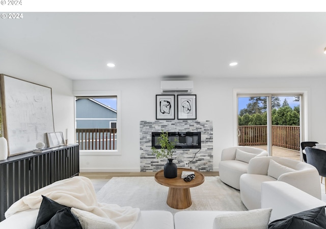 living room featuring an AC wall unit and light hardwood / wood-style flooring