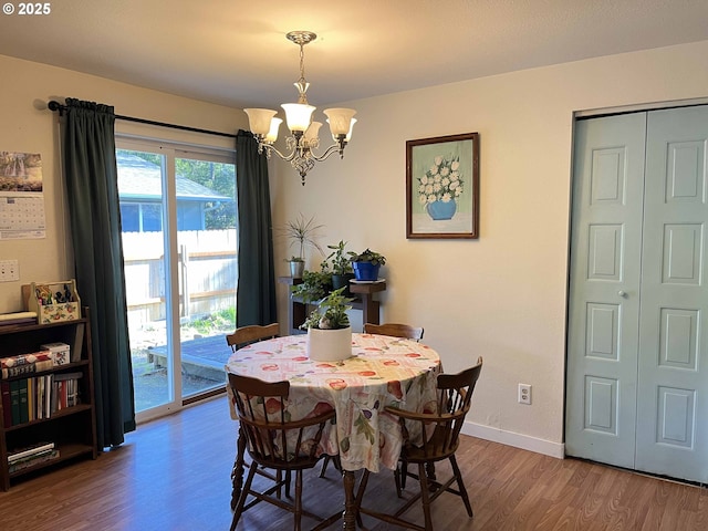 dining space featuring a notable chandelier and hardwood / wood-style flooring