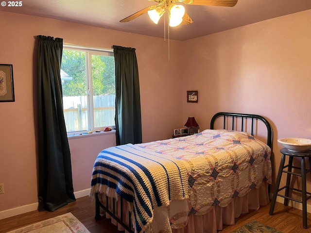 bedroom with dark wood-type flooring and ceiling fan