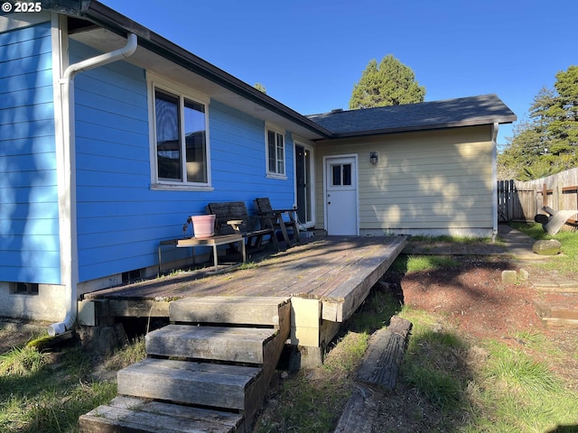 rear view of property featuring a deck