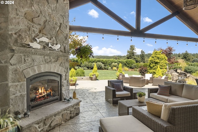 view of patio / terrace with an outdoor living space with a fireplace