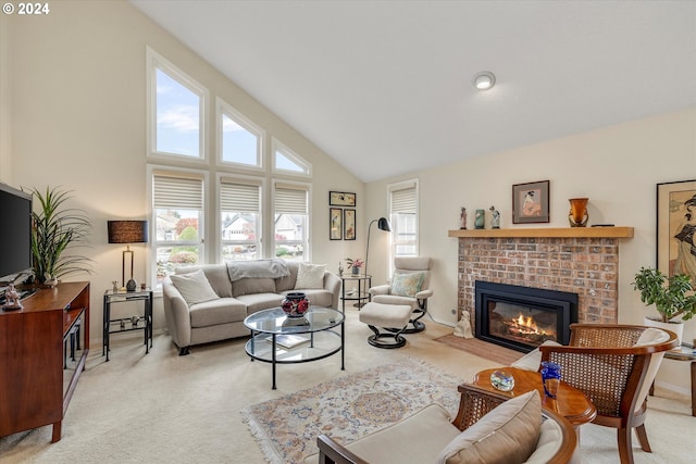 living room with high vaulted ceiling, light colored carpet, and a wealth of natural light