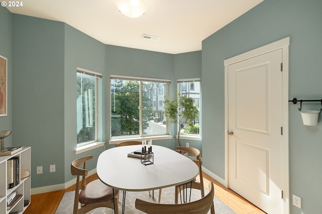 dining space with light hardwood / wood-style floors