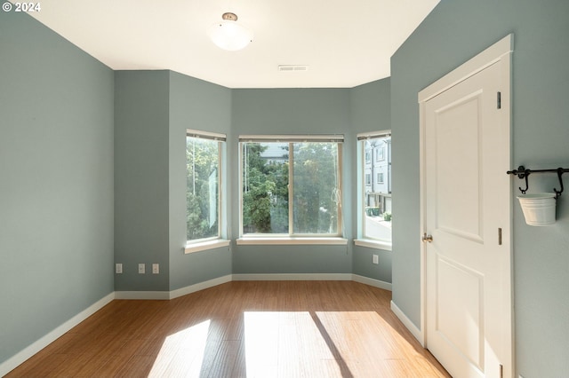 spare room with light hardwood / wood-style floors