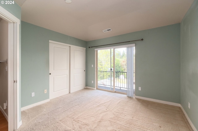 unfurnished room featuring light carpet