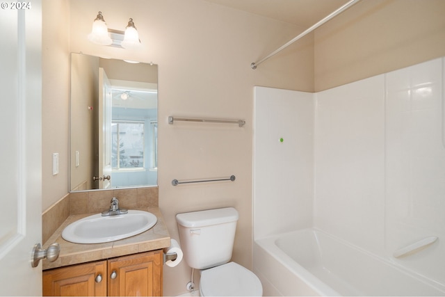 full bathroom featuring shower / bathtub combination, vanity, and toilet