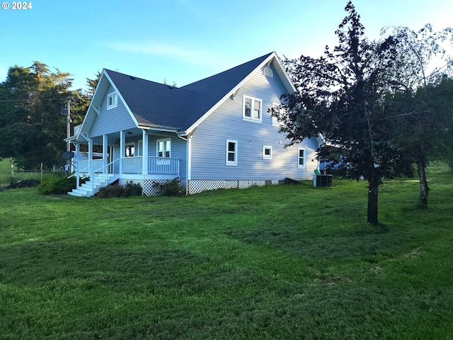 view of property exterior with a porch and a yard