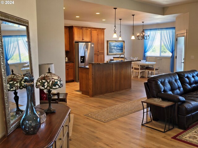 living room with a chandelier and light wood-type flooring