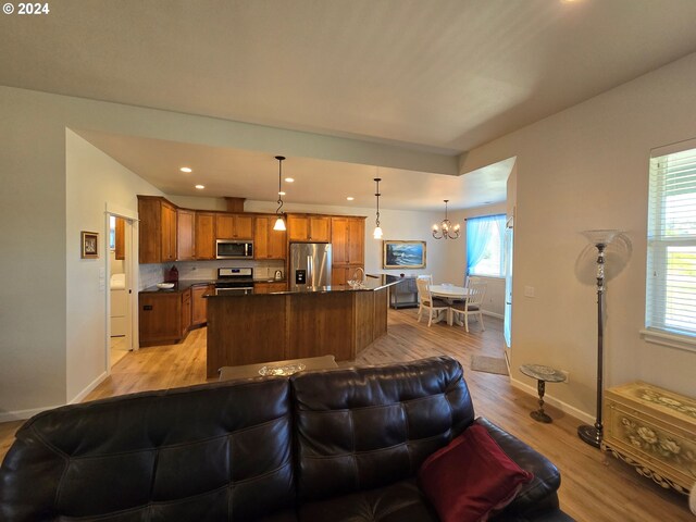 living room featuring a notable chandelier and light hardwood / wood-style floors